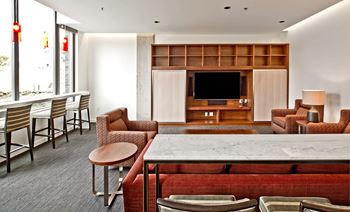 a living room with a table and chairs and a television